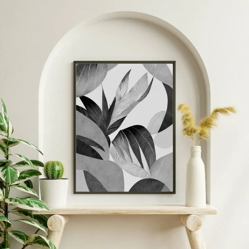 Tableau noir et blanc moderne représentant des feuilles végétales, design naturel et épuré