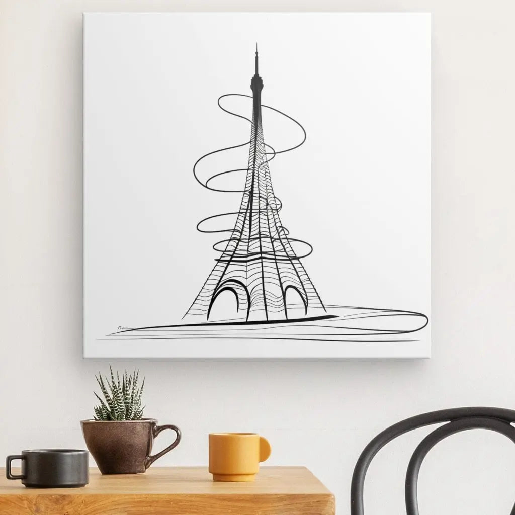 Un Tableau Tour Eiffel Abstrait Dessin Traits Moderne Noir et Blanc encadré est accroché à un mur au-dessus d'une table en bois avec une petite plante, une tasse jaune et une tasse marron. Une chaise noire est partiellement visible à droite.
