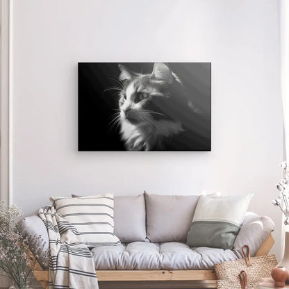 Un Tableau Chat Portrait Animal de Compagnie Noir et Blanc encadré est accroché sur un mur blanc au-dessus d'un canapé blanc avec des oreillers rayés et unis. Un panier et une plante décorative sont positionnés de chaque côté du canapé, ajoutant une touche d'élégance à la scène.