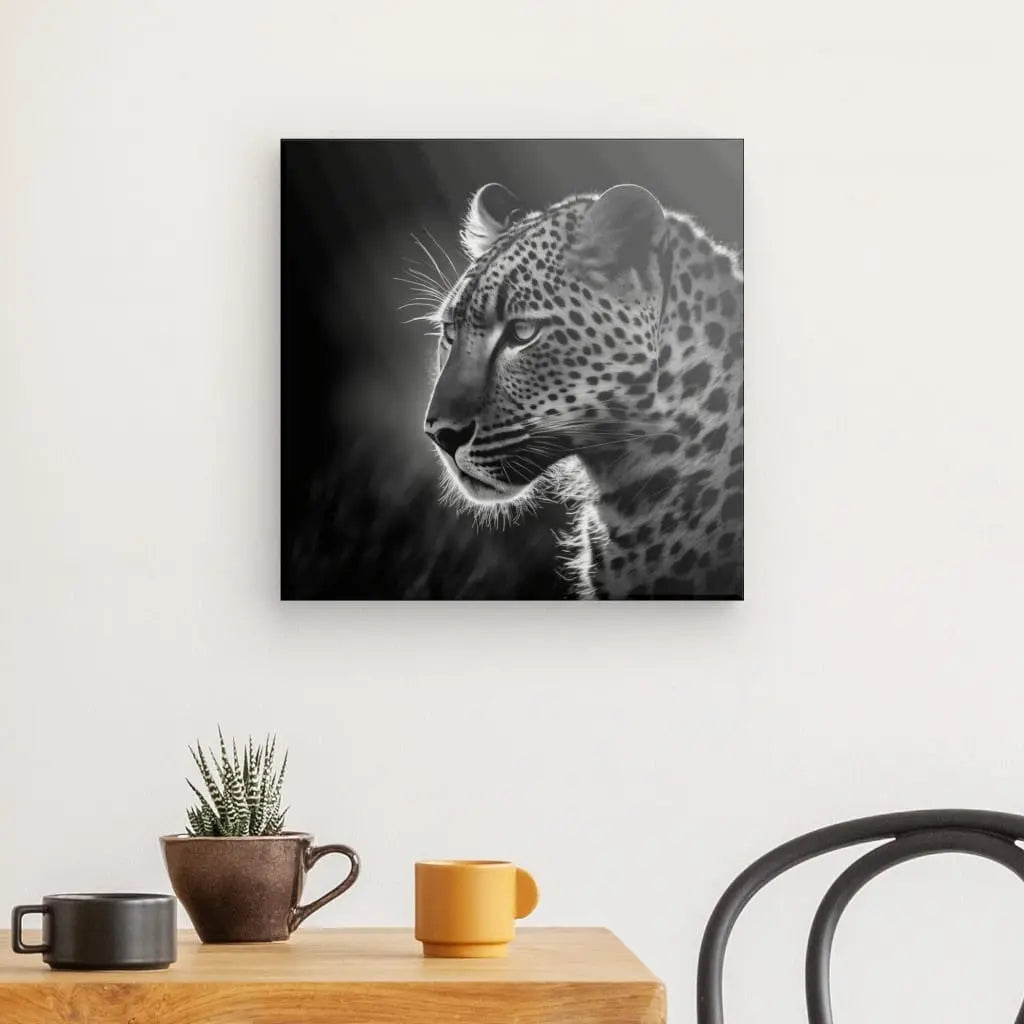 L'art mural en noir et blanc représentant un léopard, un superbe Tableau Jaguar Panthère Jungle Animal Sauvage Noir et Blanc, est monté au-dessus d'une petite table en bois avec une tasse marron, une tasse jaune et une petite plante en pot. Une chaise noire est adjacente à la table.