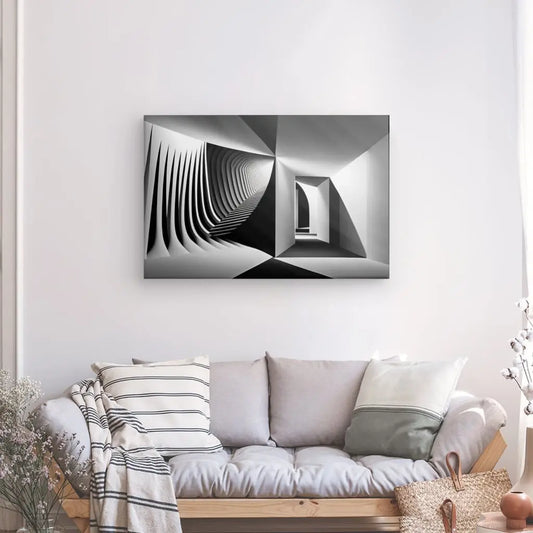 Un salon minimaliste avec un canapé gris clair. Au-dessus du canapé se trouve un Tableau Art Minimaliste Abstrait Moderne Noir et Blanc présentant des formes géométriques en noir et blanc. Une plante en pot et un panier tressé sont posés sur le sol à côté du canapé.