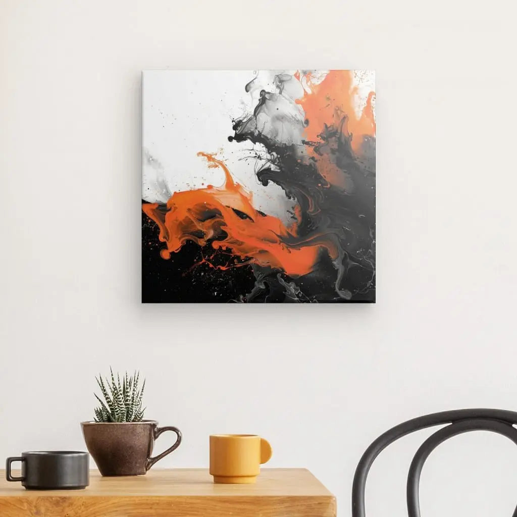 De l'art abstrait avec des touches d'orange et de noir sur fond blanc est accroché sur un mur blanc au-dessus d'une table en bois ornée de deux tasses, d'un bol, d'une petite plante et d'une chaise noire. Ce Tableau Moderne Volutes Noires Blanches et Oranges apporte une touche de sophistication à l'espace.