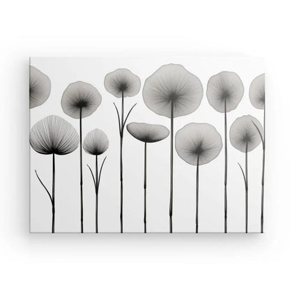 Une œuvre monochrome du Tableau Fleurs Séchées Végétaux Noir et Blanc, représentant des fleurs abstraites et minimalistes avec de fines tiges et des pétales circulaires, disposées sur un fond blanc.