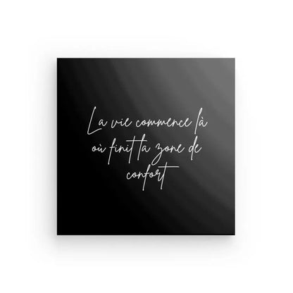 Le Tableau Citation Zone de Confort Noir et Blanc est une toile carrée noire comportant un texte français manuscrit blanc qui dit : « La vie commence là où finit ta zone de confort », ce qui se traduit par « La vie commence là où se termine votre zone de confort ». Cette pièce sert de rappel quotidien pour sortir et vivre de nouvelles expériences.