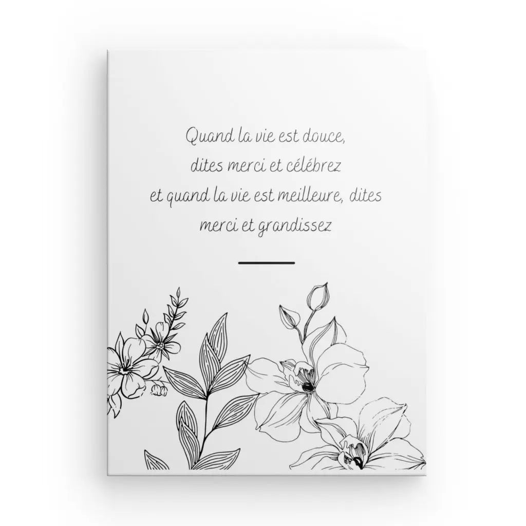 Pièce de décoration intérieure raffinée, le « Tableau Citation Fleurs et Gratitude Inversé » présente une carte blanche avec des illustrations florales noires et un texte en français au centre qui dit : « Quand la vie est douce, dites merci et célèbrez et quand la vie est meilleure. , dites merci et grandissez.