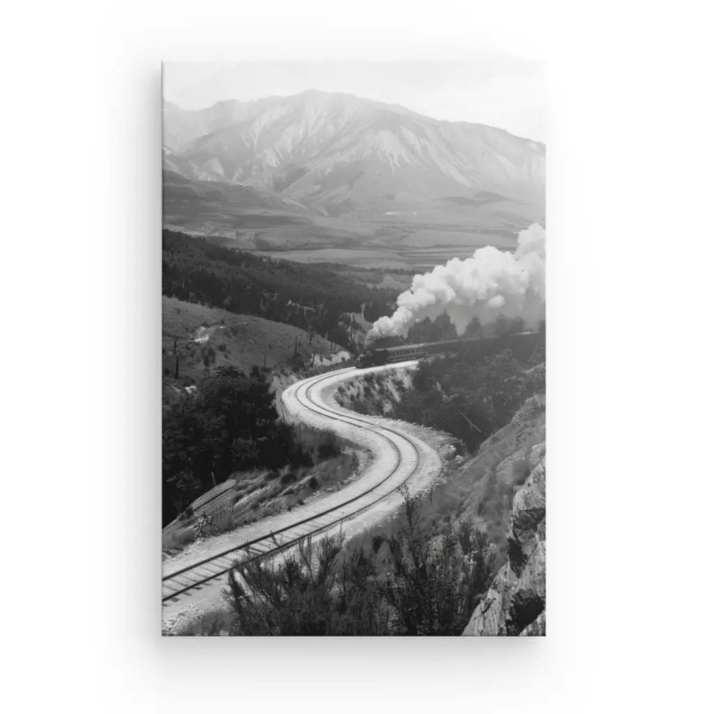 Ancient black and white locomotive train winding through mountains.