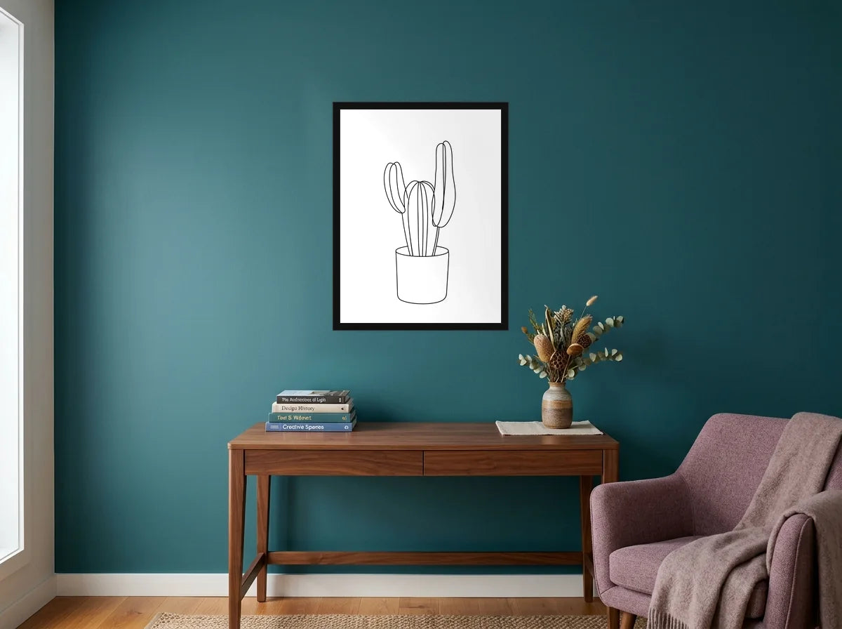 Poster Cactus au Trait noir et blanc encadré noir, présenté dans un bureau aux murs bleu canard