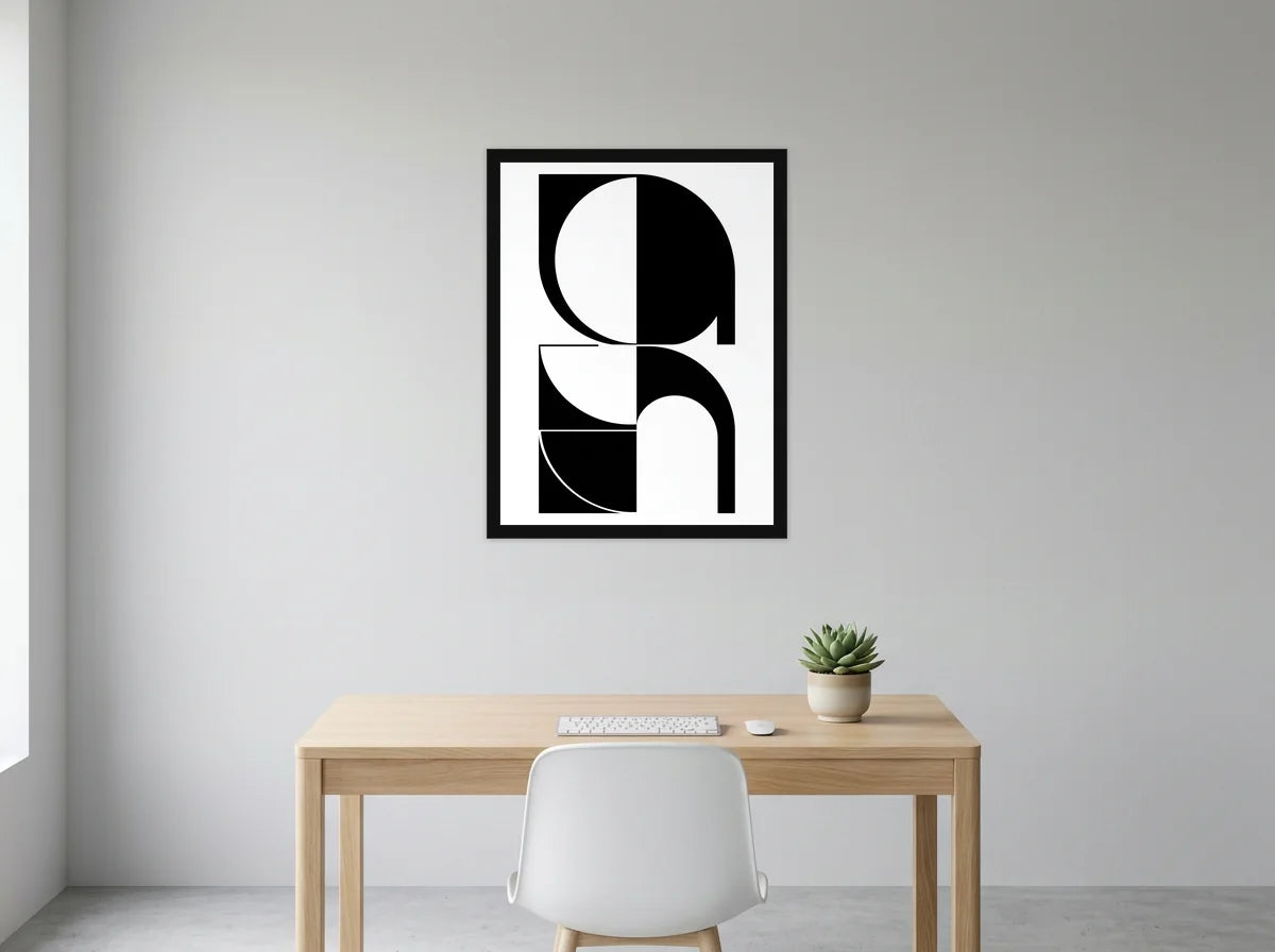 Poster composition Bauhaus arches noir et blanc encadré noir, présenté dans un bureau gris clair lumineux