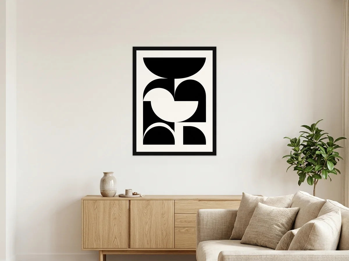 Poster composition Bauhaus géométrique noir et blanc encadré noir, présenté dans un salon blanc chaleureux et bois clair