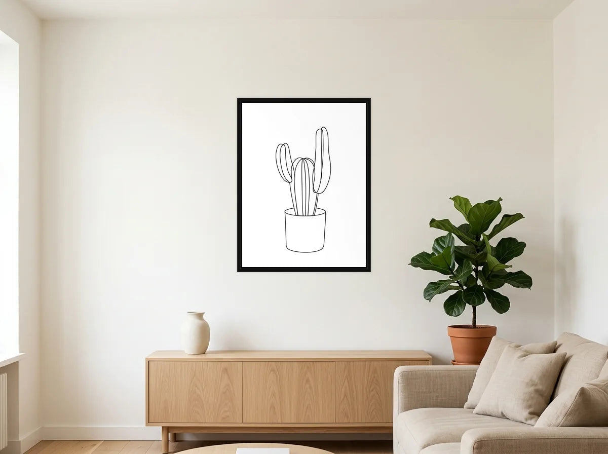 Tableau Cactus au Trait noir et blanc en toile encadrée noire, présenté dans un salon blanc chaleureux et bois clair
