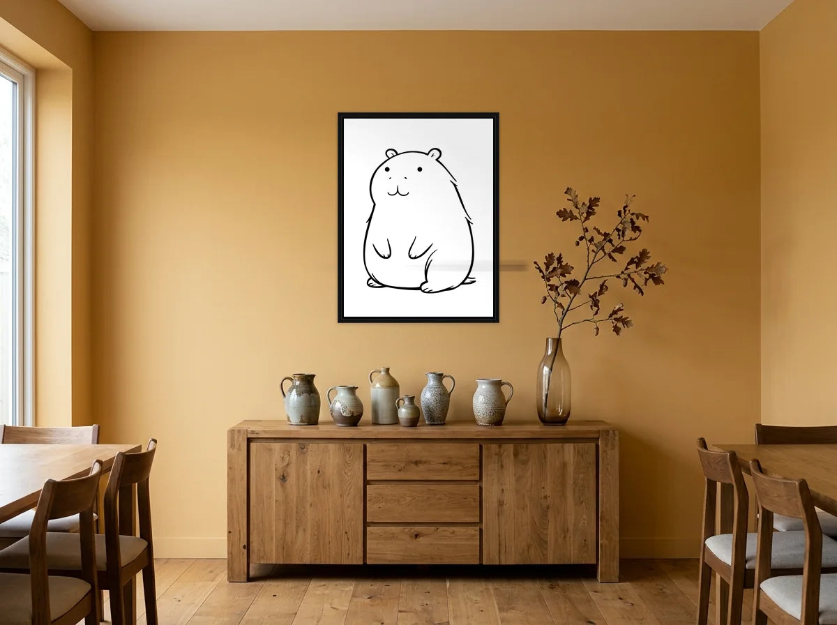 Tableau capybara assis noir et blanc en toile encadrée noire, présenté dans une salle à manger aux murs ocre