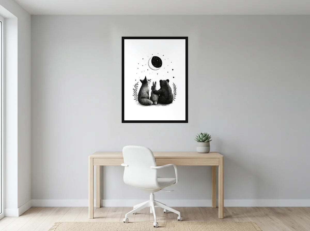Tableau Compagnons sous la Lune noir et blanc en toile encadrée noire, présenté dans un bureau gris clair lumineux