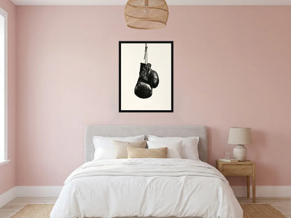 Tableau Gants de Boxe Patinés noir et blanc en toile encadrée noire, présenté dans une chambre aux murs rose poudré