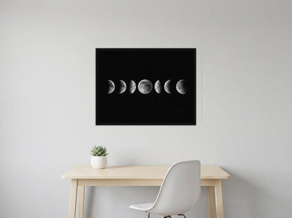 Tableau phases de lune noir et blanc en toile encadrée noire, présenté dans un intérieur contemporain