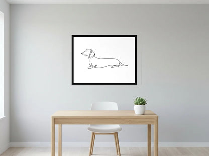 Tableau teckel au trait continu noir et blanc en toile encadrée noire, présenté dans un intérieur contemporain
