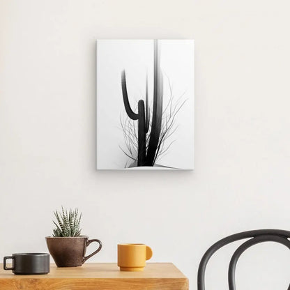 Chambre minimaliste avec une table en bois contenant deux tasses, une petite plante en pot et une chaise noire. Un Tableau Cactus Minimaliste Art Moderne Abstrait Noir et Blanc est accroché au mur blanc.