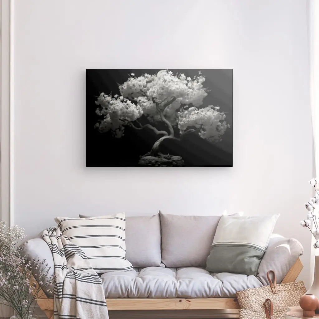 Tableau Cerisier Japonais Arbre Noir et Blanc reproduction photo sur toile tendue d'un arbre au-dessus d'un canapé de salon confortable.